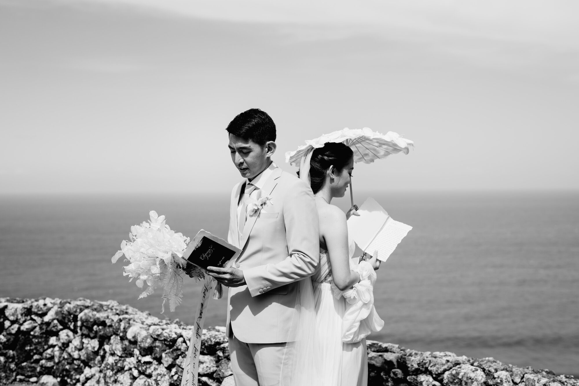 A couple beneath a parasol on the Uluwatu cliffs